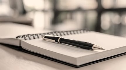 office-spiral-notebook-and-pen-900x500